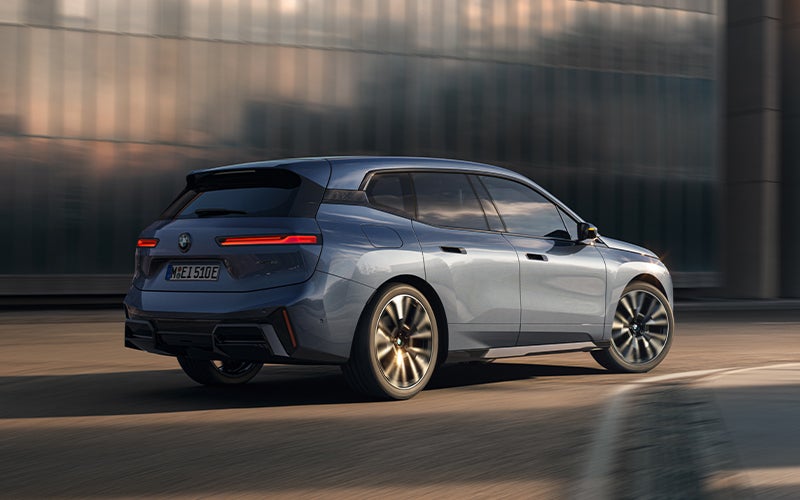 The BMW iX driving with the front wheel turned. | BMW of Eugene in Eugene OR